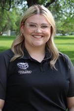 A professional headshot of Hannah Stanhope in a black Oakland University shirt.